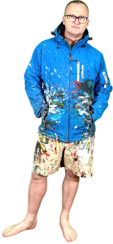 Motta Artist dressed in shorts and coat covered in paint